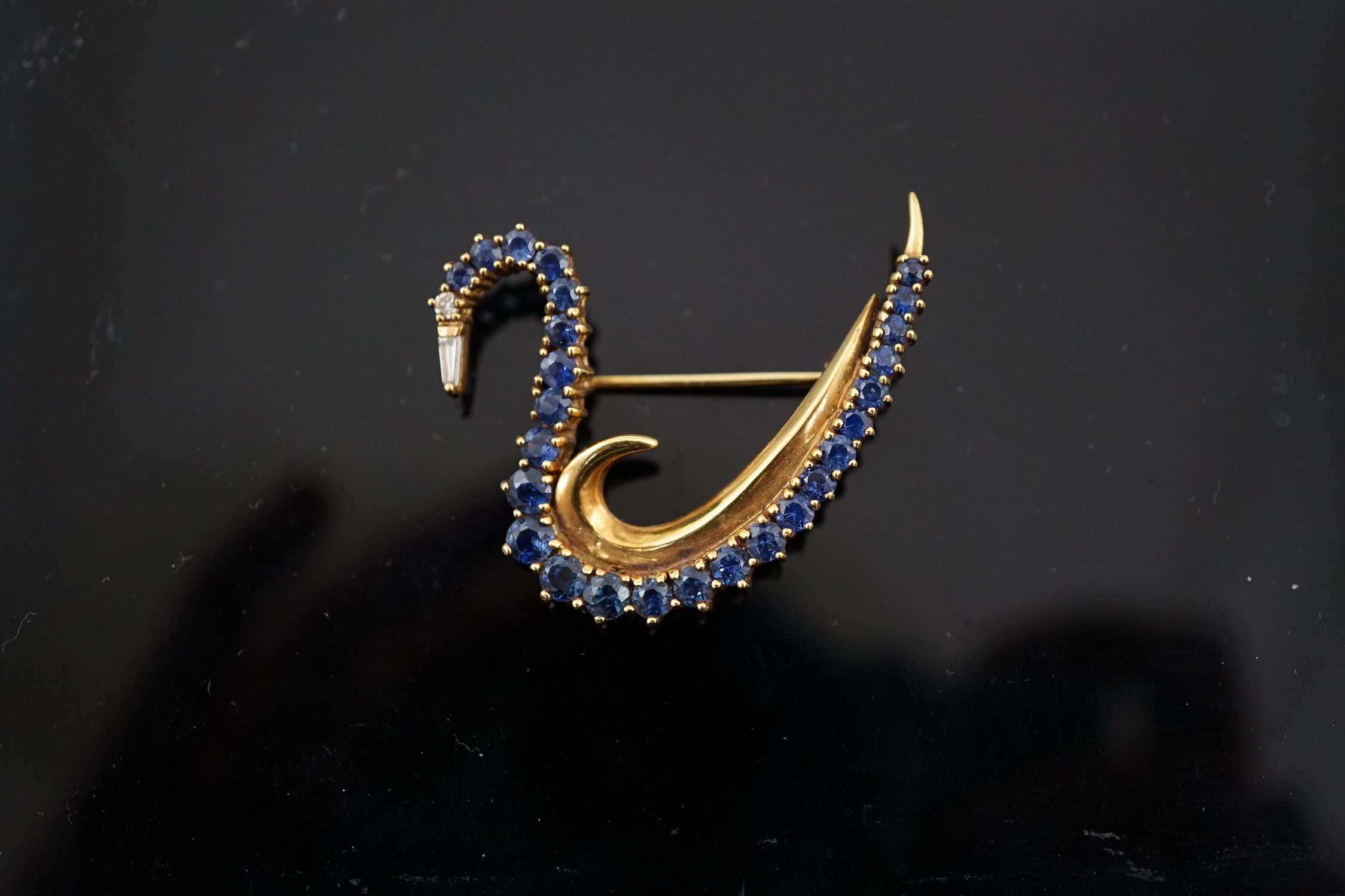 A 1990's 18ct gold, sapphire and diamond cluster brooch, modelled as a swan